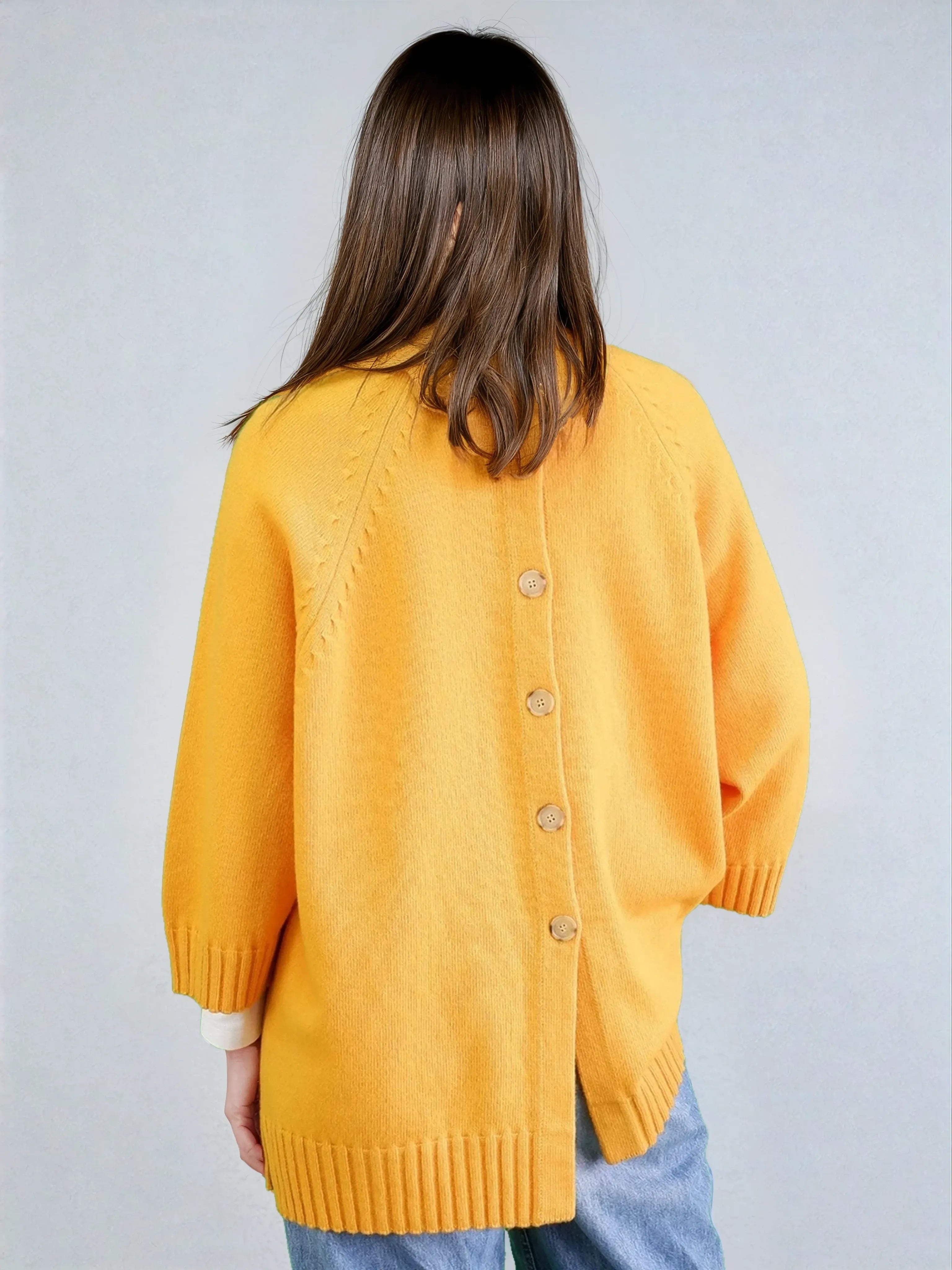 Lambswol braided poncho with buttons in yellow
